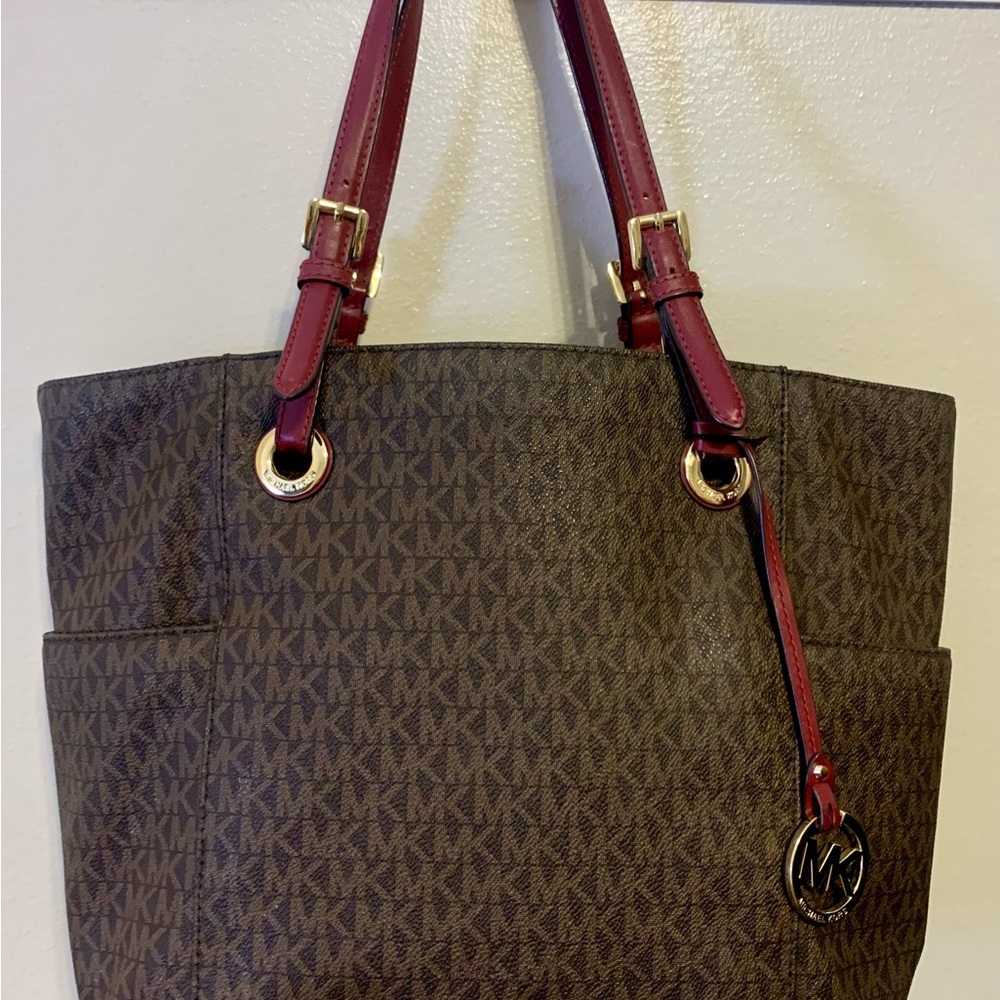 Michael Kors Jet Set East/West Signature Tote in brown with cherry red straps